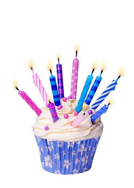 istock Birthday cupcake with many lit candles isolated on white 115458461