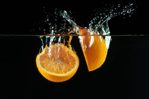 istock Orange falls into the water and making splashes 1154586784