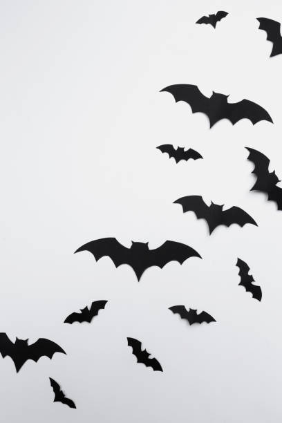 istock halloween and decoration concept - paper bats flying 1154587573