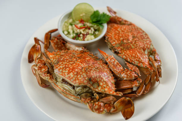 istock Steamed blue crab on white plate with spicy seafood sauce 1154587907