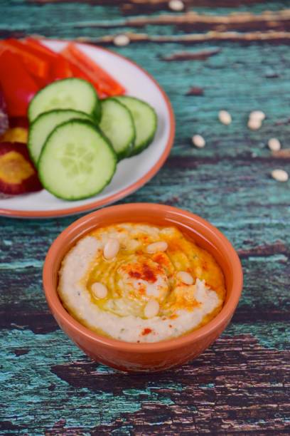 istock White bean hummus served with bell pepper, cucumber and purple carrot 1154590301