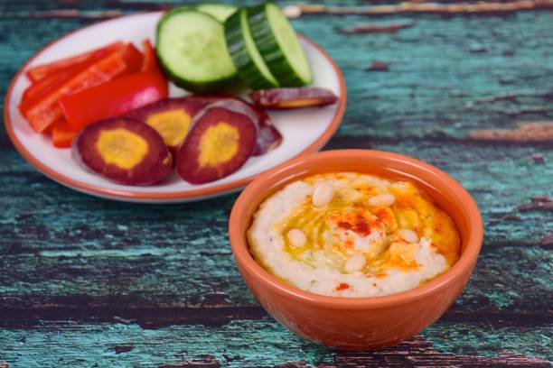 istock White bean hummus served with bell pepper, cucumber and purple carrot 1154590357