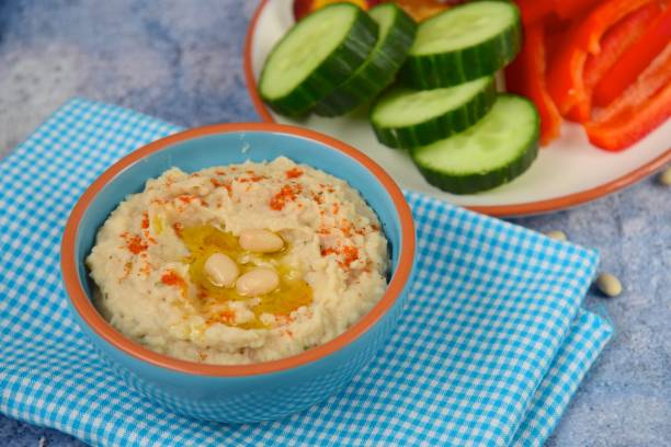 istock White bean hummus served with bell pepper, cucumber and purple carrot 1154590401
