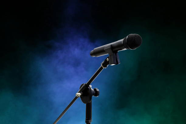 istock Microphone close up in dark night smoke background (selective focus) 1154590502