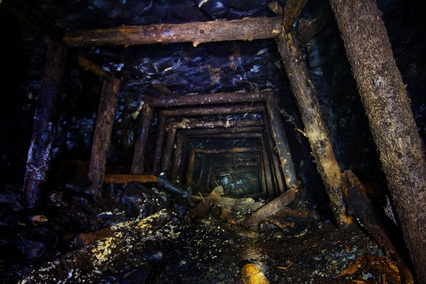 Abandoned coal mine with rotten collapsed wooden miner stands. Old derelict coal development.