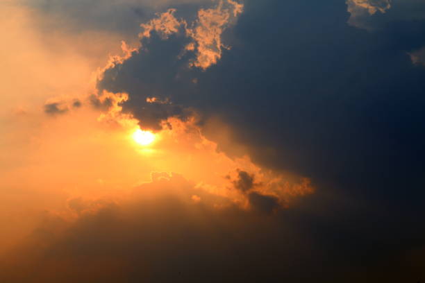 istock sunset, orange sky sun sets over cloud dark, gold sky sun lighten clouds evening 1154592841