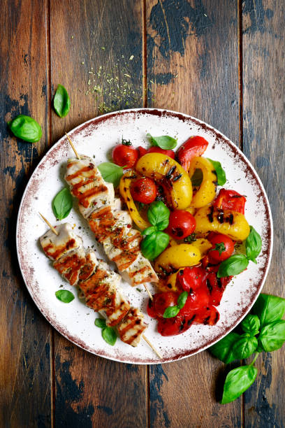 Grilled chicken skewers kebab with roasted vegetables