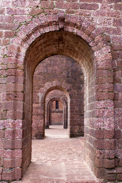 istock Red old brick tunnel door background 1154594967
