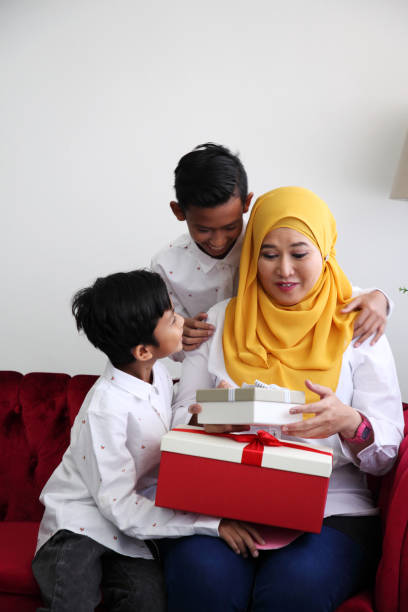 istock mother's day son giving present to mother 1154595475