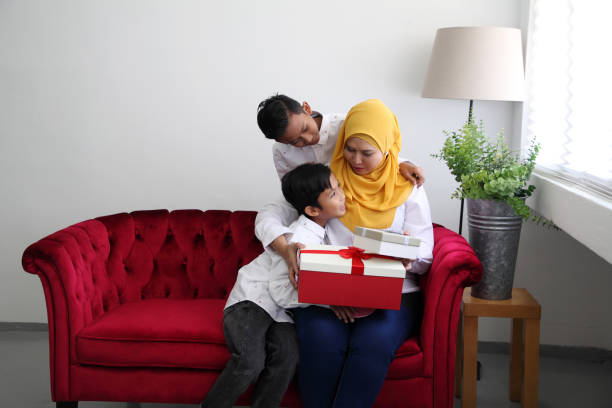 istock mother's day son giving present to mother 1154595490
