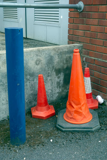 istock Abandoned Traffic Cones in Urban Back of Shops Setting 1154596519