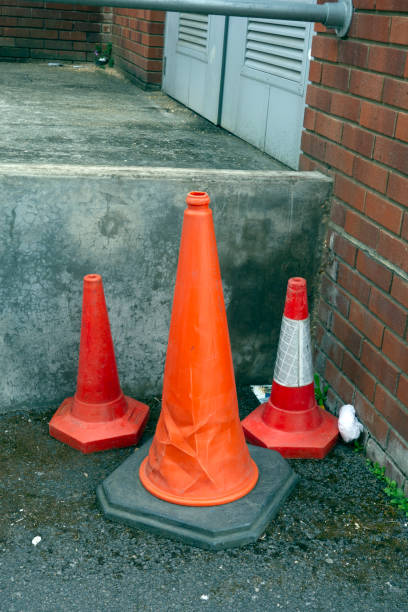 istock Abandoned Traffic Cones in Urban Back of Shops Setting 1154596553