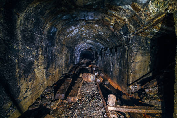 istock Dark abandoned coal mine with rusty scrap metal 1154598039