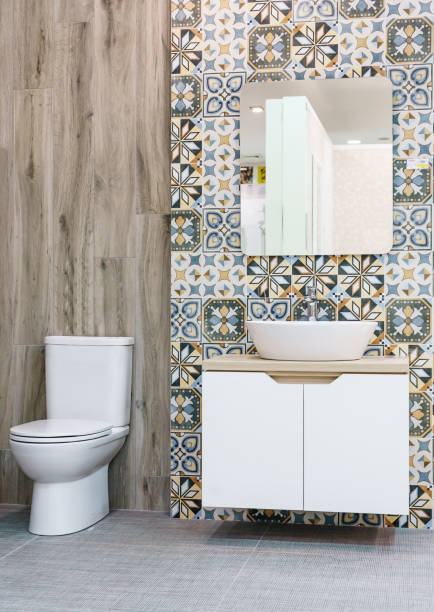 istock Modern spacious bathroom with bright tiles with toilet and sink. 1154598123