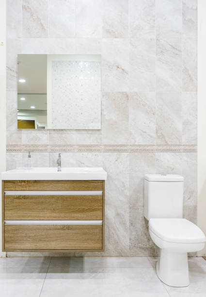 istock Modern spacious bathroom with bright tiles with toilet and sink. 1154598140