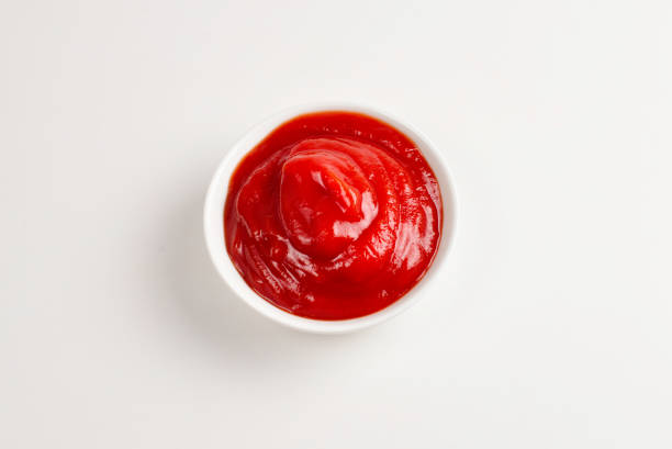 istock Ketchup in white plate on white background. 1154598289