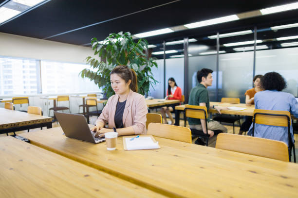 istock Business woman working in co-working space 1154599321