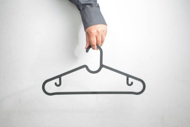 istock Men's Crew Neck Mock-Up - Man holding a copper wire clothes hanger 1154601821