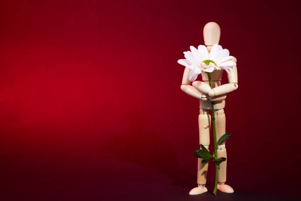 istock A wooden man holds a cross. 1154601942