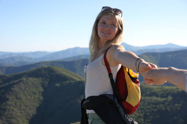 istock Female hiker gives friend a helping hand 1154603747