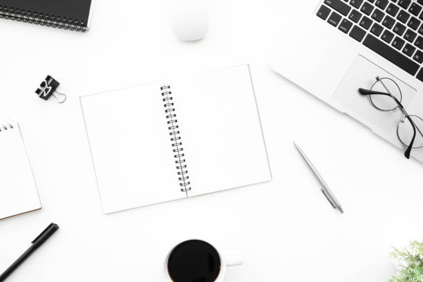 istock White office desk table with two blank pages of notebook with supplies. Top view with copy space, flat lay. 1154604592