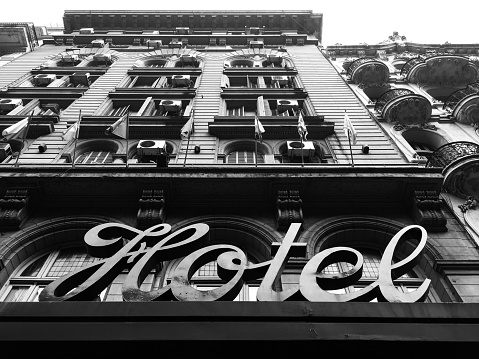 Buenos Aires, Argentina - June 6, 2019: Low angle view of old hotel building and sign located on the famous Avenida de Mayo. At the beginning of the 20th century and with the advent of the 100th anniversary of the country, lots of hotels where built here in order to receive the future visitors of the event
