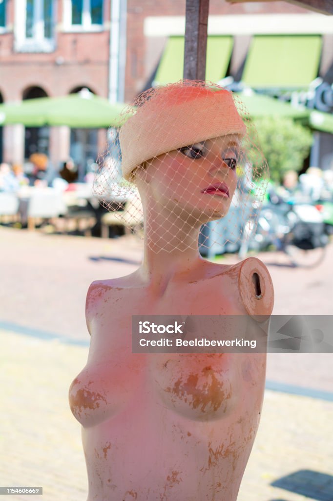 Bonnet beauty lost her arms Mannequin without arms Flea Market Stock Photo