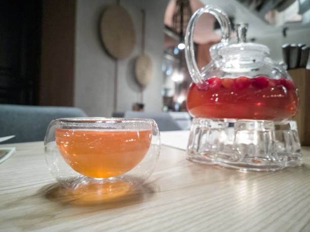 istock Fruit tea in glass teapot and cup in restaurant 1154607465