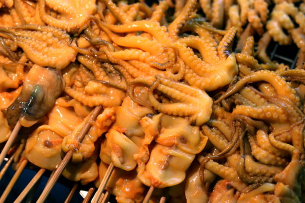 istock Squid, Fresh squid on panel grid rack in the market 1154615477