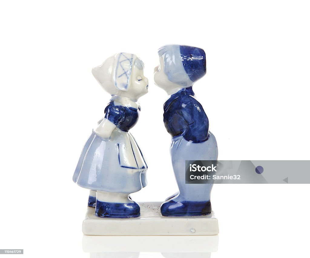 A blue and white Delft style Dutch figurine souvenir Typical Dutch souvenir in Delft blue over white background Delftware Stock Photo