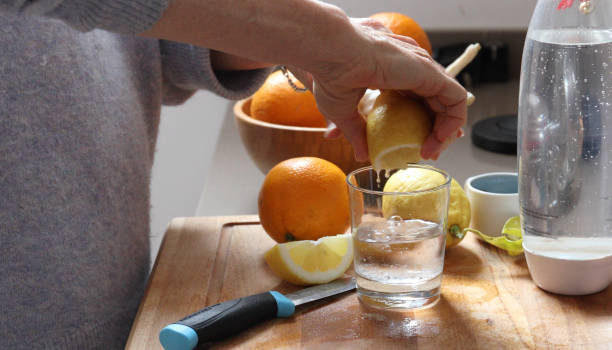 istock woman lemon water kitchen 1154619762