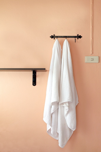 towel, a towel hangs on an orange wall (selective focus)