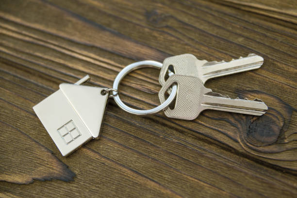 istock House keys on a wooden background, closeup. 1154623131