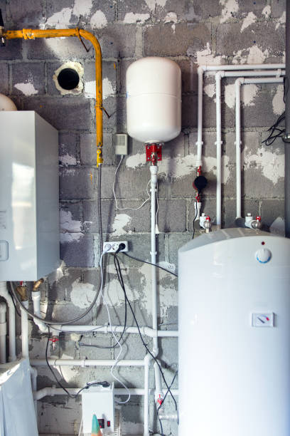 istock Boiler room in a private house. Heating system. Pumps, tubes and valves 1154623714