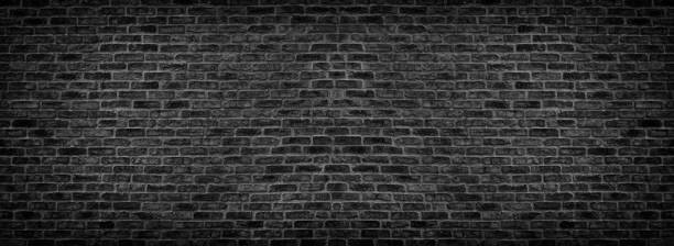 istock Wide black brick wall texture. Old rough brickwork panorama. Dark panoramic background 1154625712