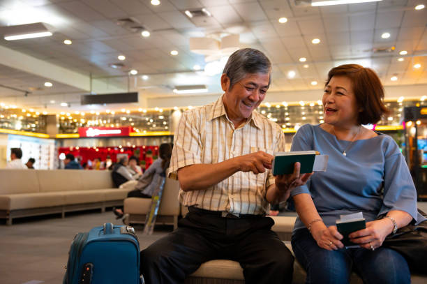 istock Cheerful couple talking in illuminated airport 1154625854