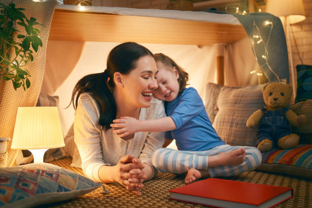 istock mother and daughter playing in tent 1154626783