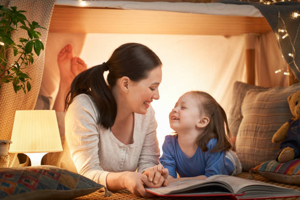 istock mother and daughter playing in tent 1154626785