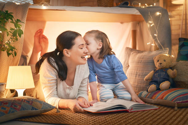 istock mother and daughter playing in tent 1154626806