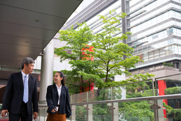 istock Business executives walking in office corridor 1154627023