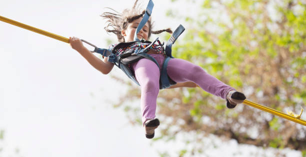 istock Little girl jumping on the bungee 1154627821