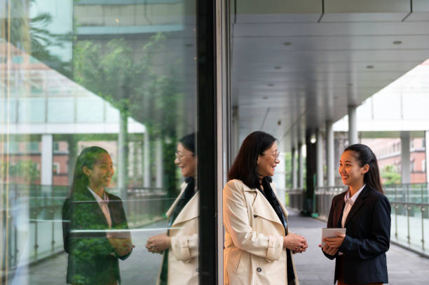 istock Smiling female entrepreneurs talking in corridor 1154628069