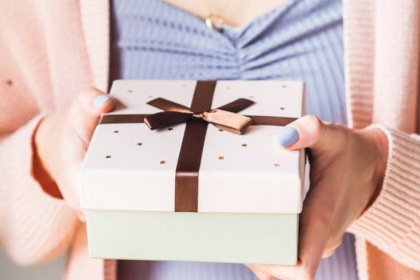 istock Woman holding gift box with bow. Pastel 1154628159