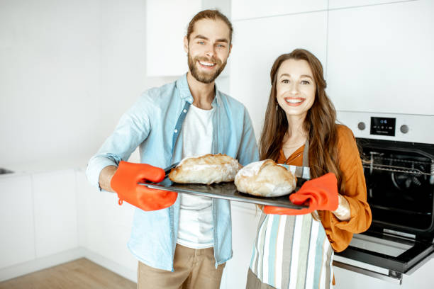 istock Couple with fresh breads at the kitchen 1154631873