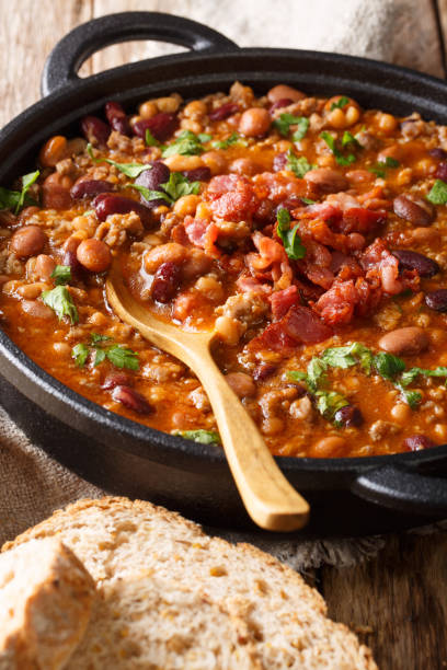 istock cowboy beans with ground beef, bacon and herbs close-up. vertical 1154631915