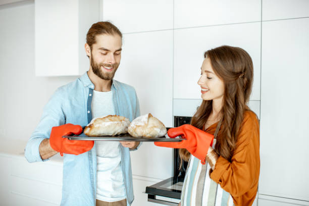 istock Couple with fresh breads at the kitchen 1154631918