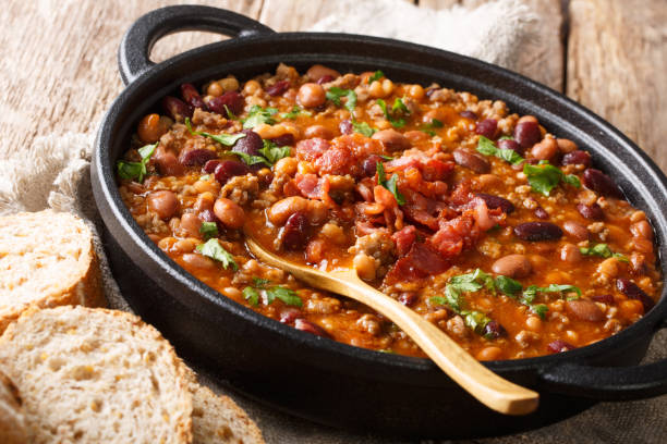 istock Crock pot beans with ground beef, bacon in a spicy sauce closeup on the table. horizontal 1154632941
