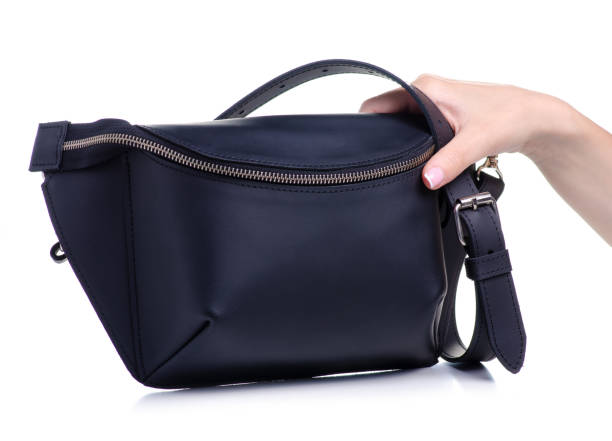 istock Black leather waist bag in hand 1154633094