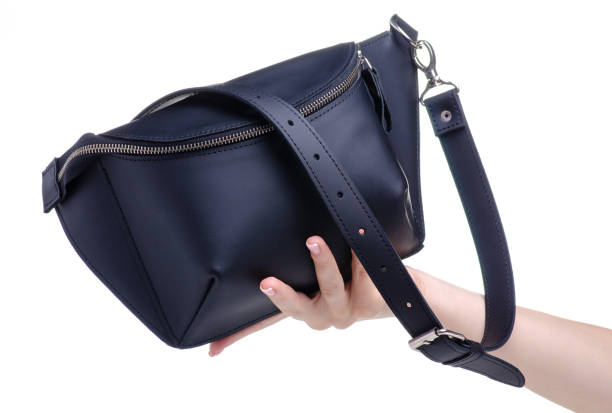 istock Black leather waist bag in hand 1154633109