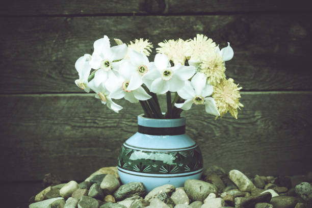 istock Flowers in an old vase. Dandelions and daffodils. 1154633175